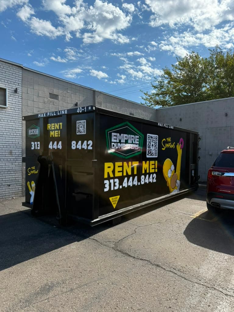 Empire Dumpsters 40 yard roll-off dumpster staged behind a commercial building