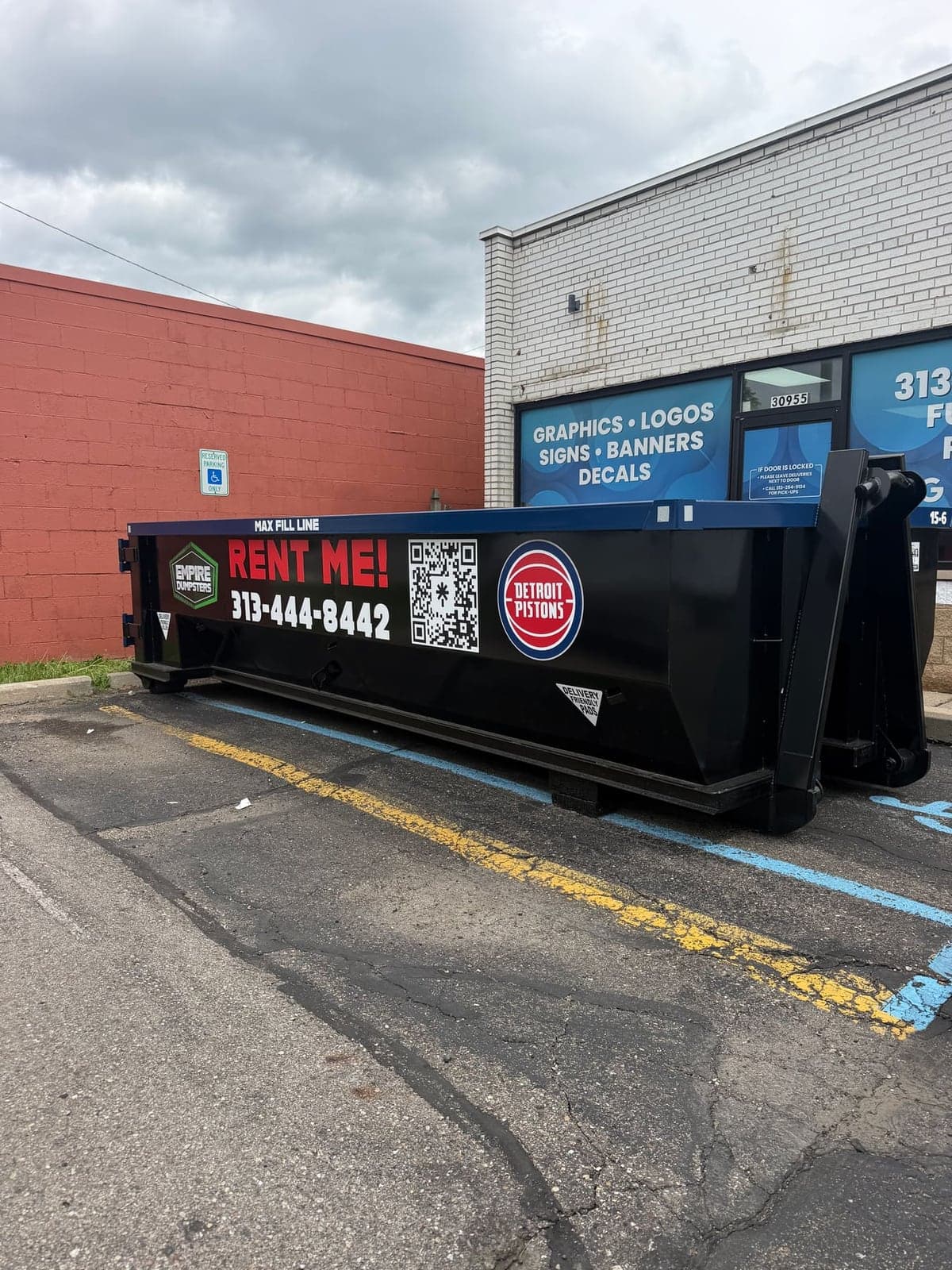 Empire Dumpsters roll-off dumpster staged in a commercial parking lot