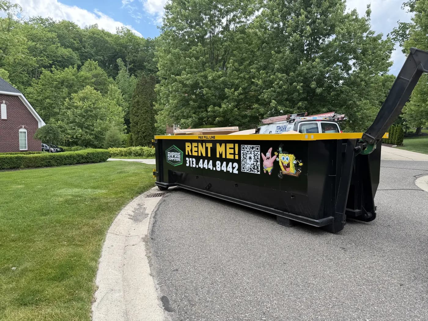 Empire Dumpsters roll-off dumpster placed on a residential driveway for a home cleanout