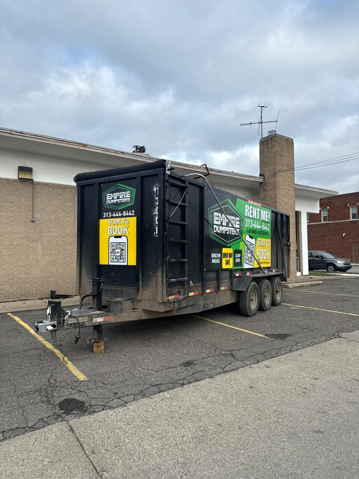 Empire Dumpsters roll-off container at a Dearborn commercial property during a retail cleanout