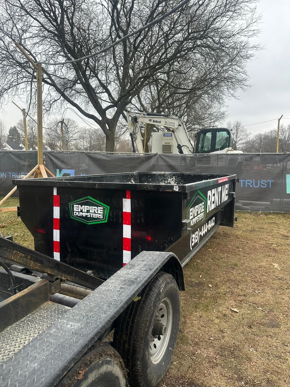 Roll-off dumpster staged at a commercial loading dock in Dearborn