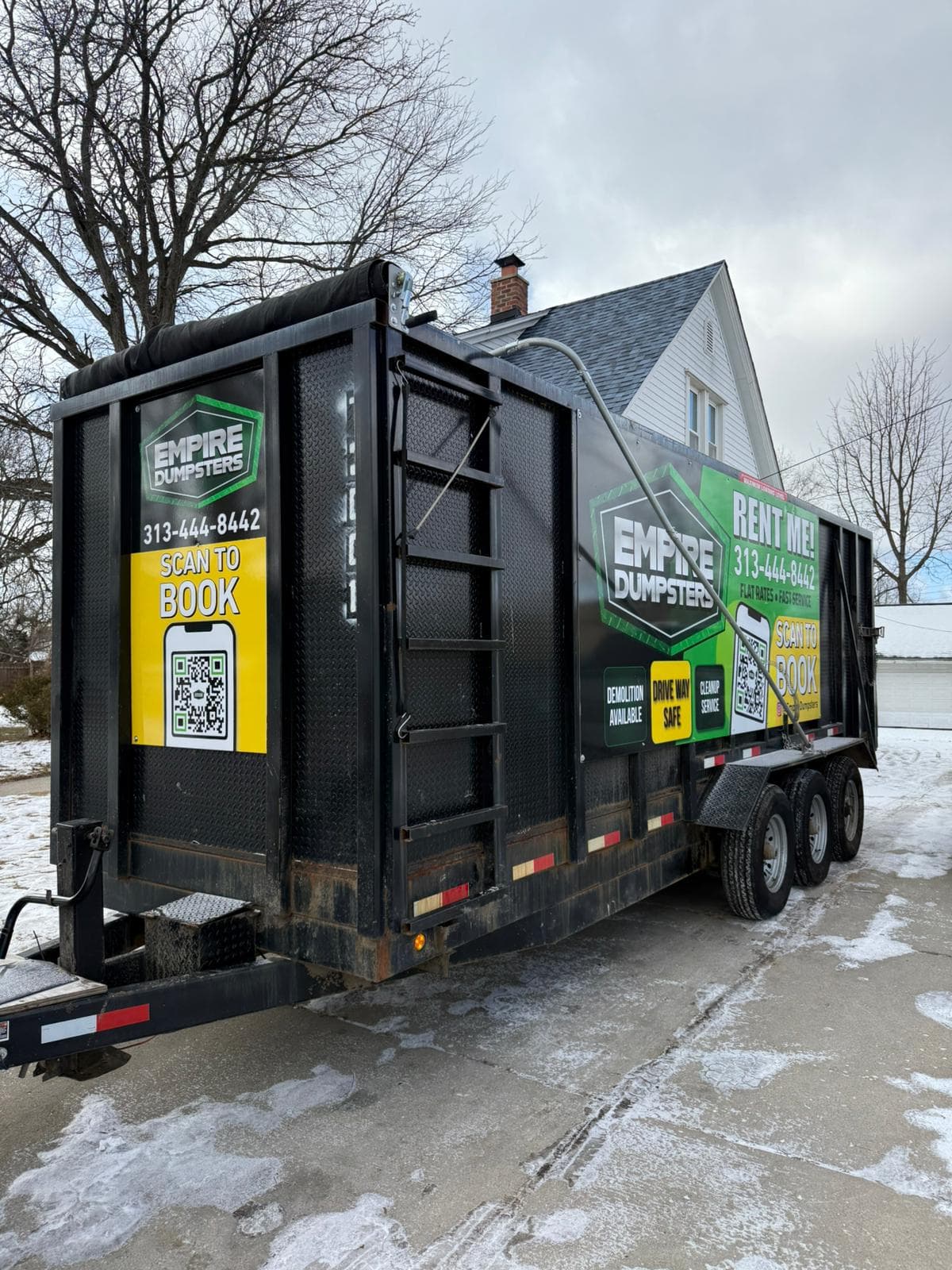 Empire Dumpsters roll-off container placed in a residential Dearborn driveway for a home cleanout